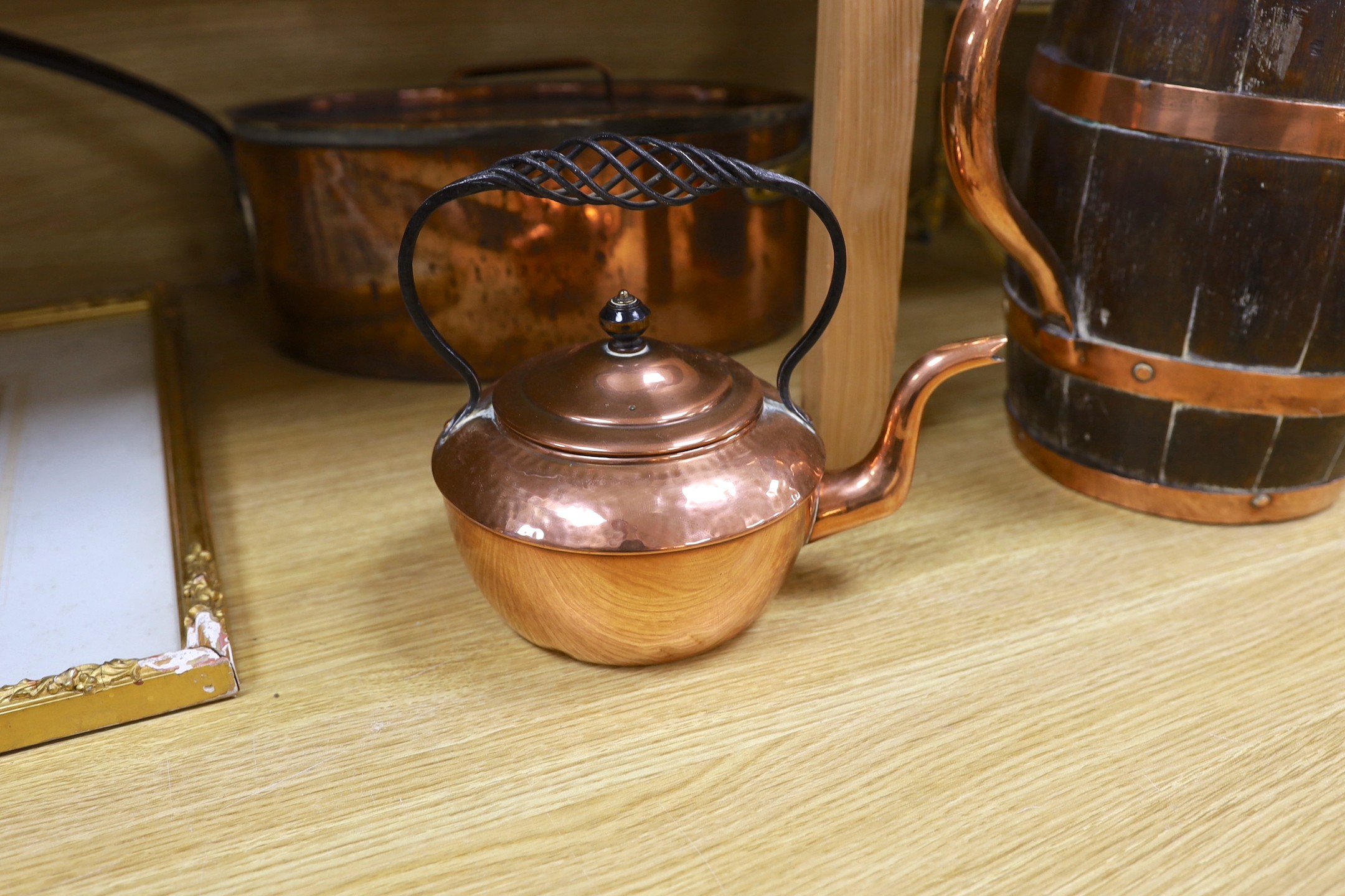 Sundry brass and copper, including a brass fireman’s helmet, a coal helmet, a staved and coopered wood and copper jug, a Victorian brass warming pan, a Victorian copper warming pan, a Victorian brass kettle etc.